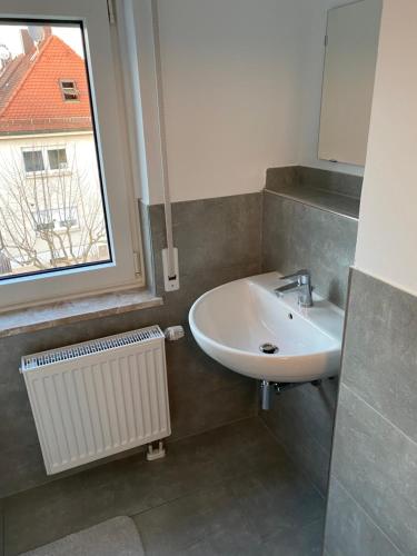 a bathroom with a sink and a window at Ferienhaus-Zirndorf in Zirndorf