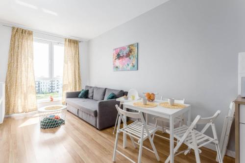 a living room with a table and a couch at Chill Apartments Airport Ursynów in Warsaw