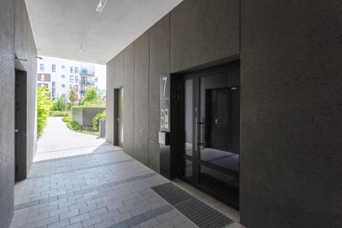 a hallway of a building with a large glass door at Chill Apartments Airport Ursynów in Warsaw