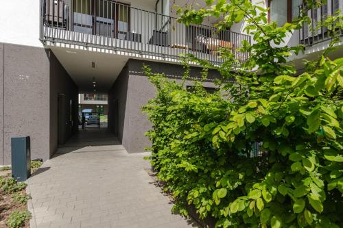 a walkway leading to a building with a balcony at Chill Apartments Airport Ursynów in Warsaw
