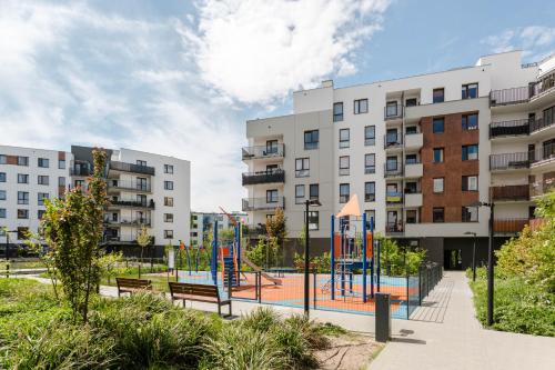 a playground in a park in front of buildings at Chill Apartments Airport Ursynów in Warsaw