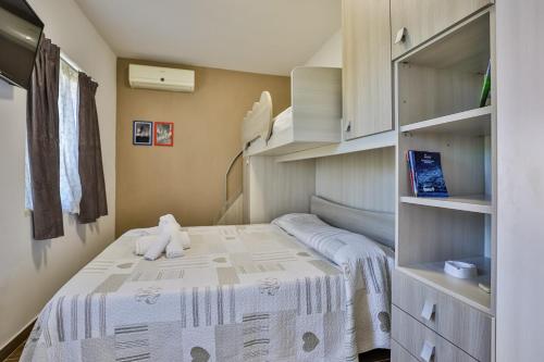 a small bedroom with a bed with a teddy bear on it at Il Pineto Paestum Food & Rooms in Paestum