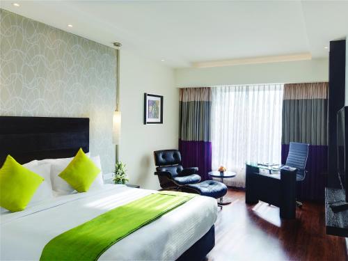 Säng eller sängar i ett rum på HYCINTH Hotels