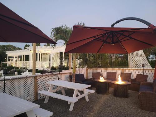 a patio with a table and two chairs and an umbrella at The Shore Club in Spring Lake Heights