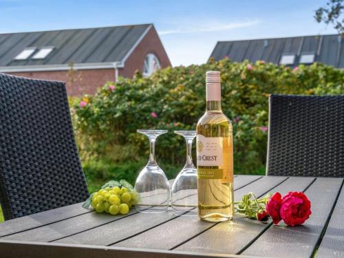 een fles wijn en twee glazen op een tafel bij Apartment Palni - 2-3km from the sea in Western Jutland by Interhome in Sønderby