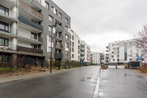 an empty street in front of a building at Chill Apartments Airport Ursynów in Warsaw