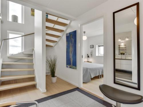a hallway with stairs and a room with a bed at Holiday Home Leto - 2km from the sea by Interhome in Havneby