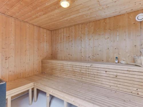 a wooden sauna with two benches in a room at Holiday Home Leto - 2km from the sea by Interhome in Havneby
