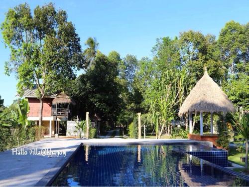 a swimming pool with a gazebo and a house at Hallo Villa Khanom in Khanom