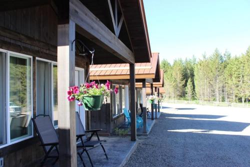 a porch of a building with a flower pot on it at Single Cabin Unit 5 in Rea