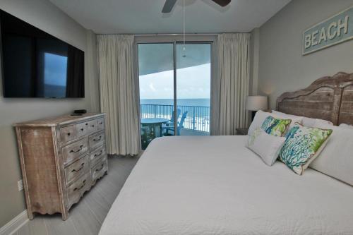 1 dormitorio con 1 cama grande y vistas al océano en Lighthouse 515, en Gulf Shores