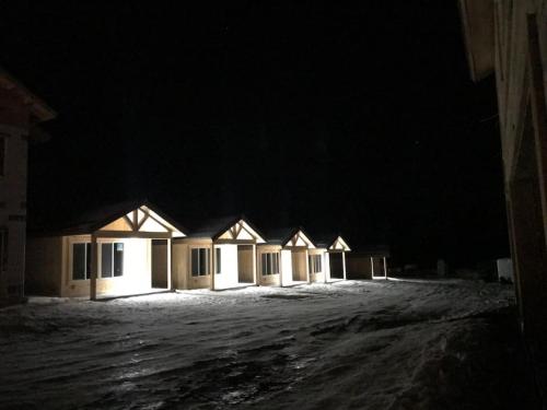 a row of houses in the snow at night at Single Cabin Unit 3 in Rea