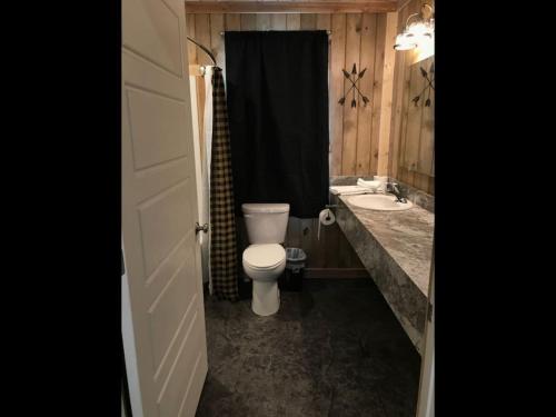 a bathroom with a toilet and a sink at Single Cabin Unit 3 in Rea