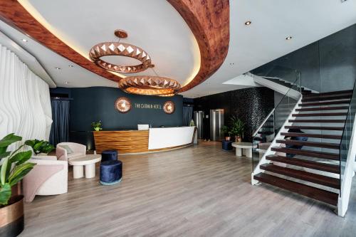 a lobby with a staircase and a stair case at The Carmen Hotel - Ocean Front in Playa del Carmen