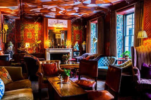 a living room filled with furniture and a fireplace at The Zetter Clerkenwell in London