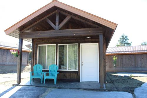 a pavilion with two chairs and a table and a white door at Single Cabin Unit 2 in Rea