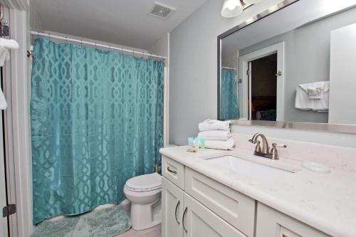 a bathroom with a sink and a toilet and a mirror at Phoenix X 1208 in Orange Beach