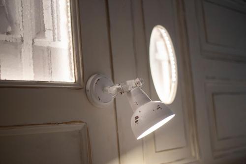 a white light on a wall next to a window at Landidyll Hotel Haus Hochstein in Wenholthausen