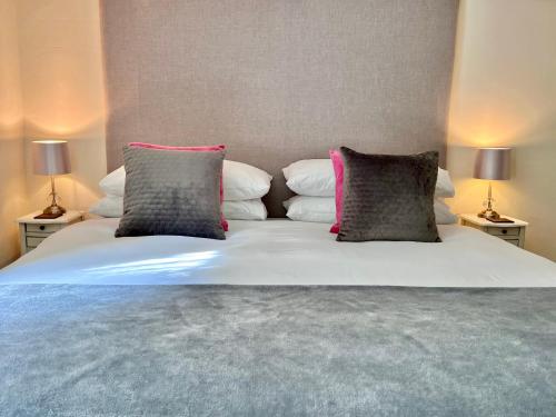 a bed with two pillows on top of it at Gate Cottage in Matlock