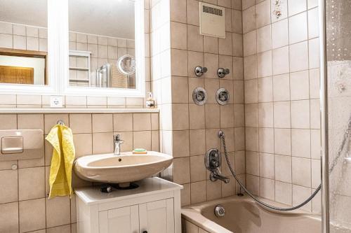 La salle de bains est pourvue d'un lavabo, de toilettes et d'une douche. dans l'établissement FEWO Hans-Peter, à Oberstaufen
