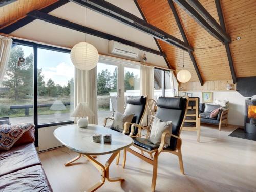 a living room with a table and chairs at Holiday Home Gerdis - 1-6km from the sea in Western Jutland by Interhome in Blåvand