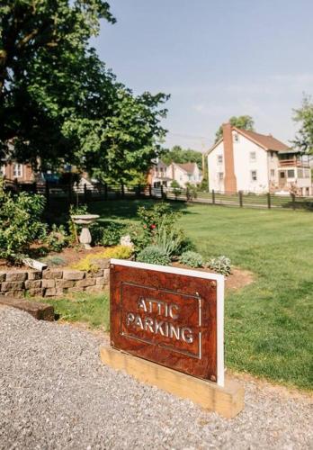 a sign that says attic parking in a yard at Creative Private Attic 1br Suite in Honey Brook