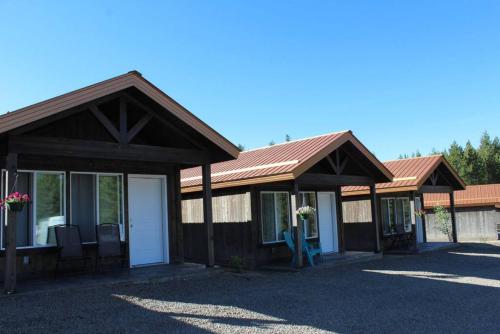 a building with two pavilions with chairs in front at Single Cabin Unit 4 in Rea