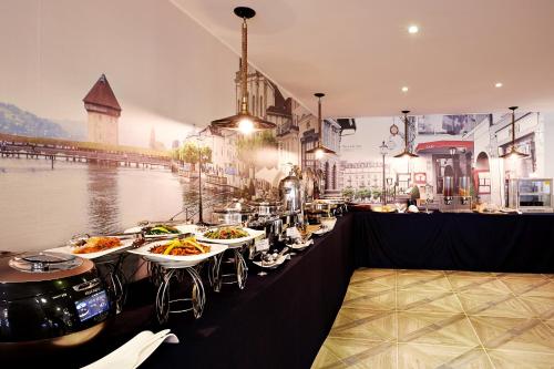 a restaurant with plates of food on a table at Hotel Namoo Cheong-ju in Cheongju