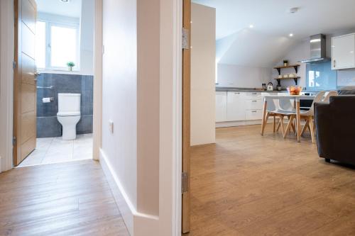a room with a kitchen and a dining room at James Charles Apartments in Bletchley