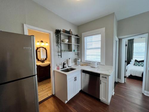 a kitchen with a sink and a refrigerator at Updated Condo in Heart of Tampa 2 in Tampa