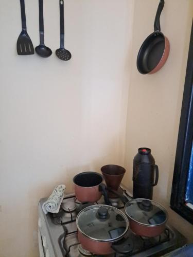 a stove with pots and pans on top of it at São Francisco do Sul - Vila da Glória - Falansterio dos Franceses in São Francisco do Sul