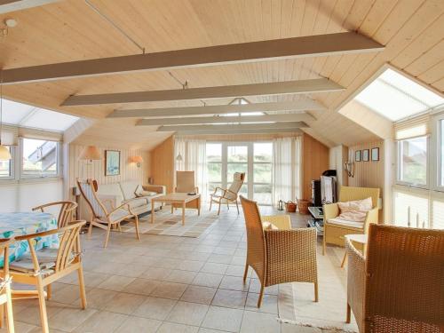 a living room with chairs and a table at Holiday Home Drusilla - 800m from the sea in Western Jutland by Interhome in Hvide Sande