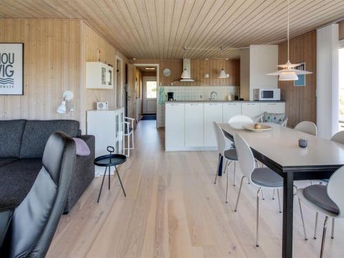 a living room and kitchen with a table and chairs at Holiday Home Gundine - from the sea in Western Jutland by Interhome in Ringkøbing