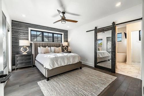 a bedroom with a bed and a ceiling fan at The Rooftop Terrace on the Square in Bentonville
