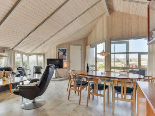 a living room with a dining room table and chairs at Holiday Home Tuure - from the sea in Western Jutland by Interhome in Bjerregård