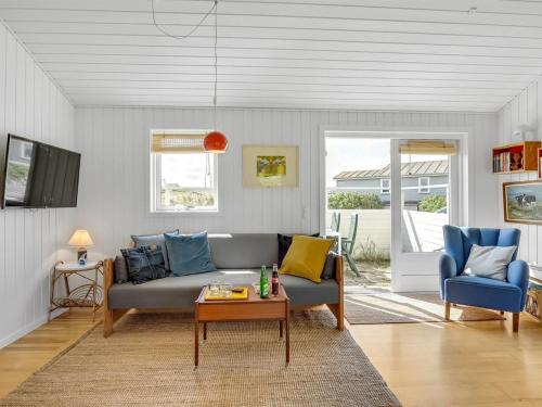 a living room with a couch and two chairs at Holiday Home Köbes - 200m from the sea by Interhome in Ringkøbing