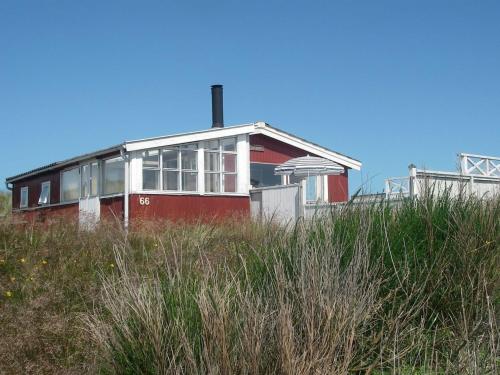 a red house on the top of a hill at Holiday Home Annelotte - from the sea by Interhome in Bjerregård