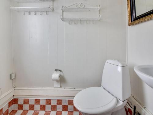 a white bathroom with a toilet and a sink at Holiday Home Annelotte - from the sea by Interhome in Bjerregård