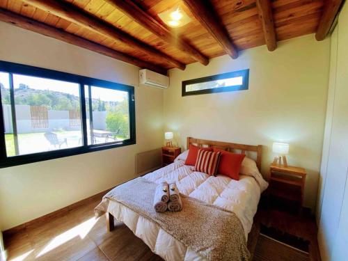 sypialnia z łóżkiem i dużym oknem w obiekcie Mountain Charm w mieście Lujan de Cuyo