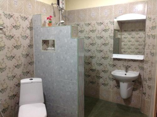 a bathroom with a toilet and a sink at Ruan Mai Naiyang Beach Resort in Nai Yang Beach