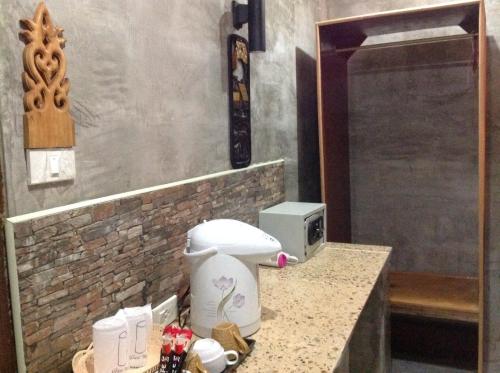 a bathroom with a toilet on a counter at Ruan Mai Naiyang Beach Resort in Nai Yang Beach