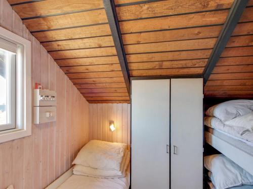 a small room with two beds and a ceiling at Holiday Home Hildegart - from the sea by Interhome in Bjerregård