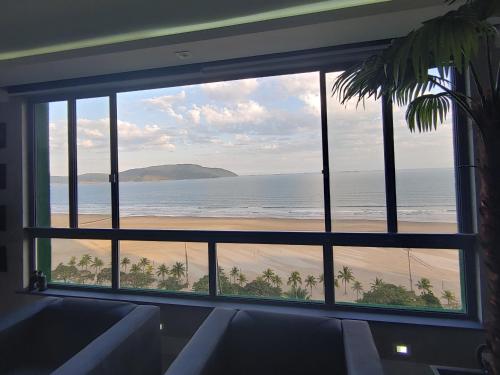 a view of the beach from a window at Oceanview Santos Gonzaga in Santos
