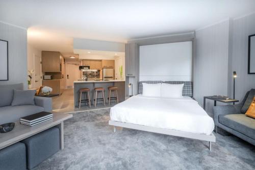 a bedroom with a bed and a living room at Lake Louise Inn in Lake Louise