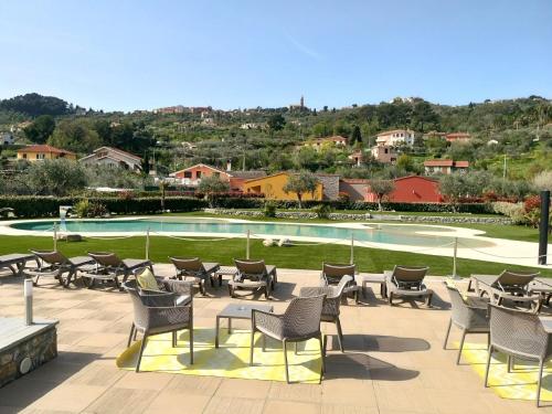 a patio with chairs and a swimming pool at ReBi Village in Imperia