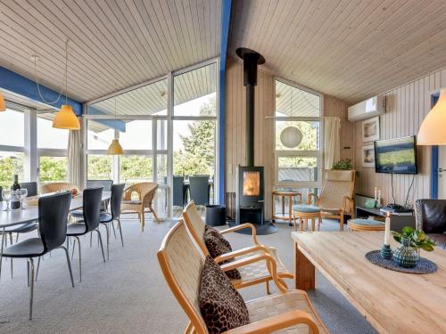 - un salon avec une table et des chaises dans l'établissement Holiday Home Andrie - 800m from the sea in Western Jutland by Interhome, à Hvide Sande