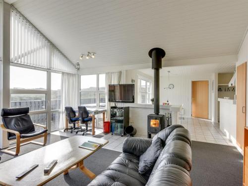 a living room with a couch and a fireplace at Holiday Home Gottfreda - 330m to the inlet in Western Jutland by Interhome in Havrvig