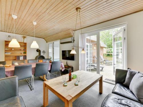 a living room with a wooden ceiling at Holiday Home Thana - 1-4km from the sea by Interhome in Ulfborg