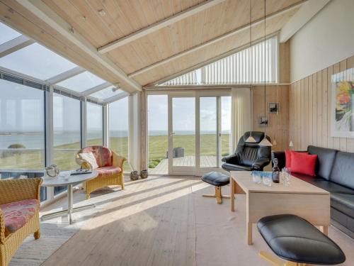 a living room with a view of the ocean at Holiday Home Rajna - 95m to the inlet by Interhome in Lemvig