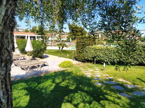 a park with a picnic table and a tree at ReBi Village in Imperia